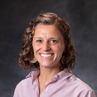 Headshot with a gray background.